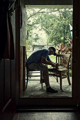 Man sitting down while woodworking